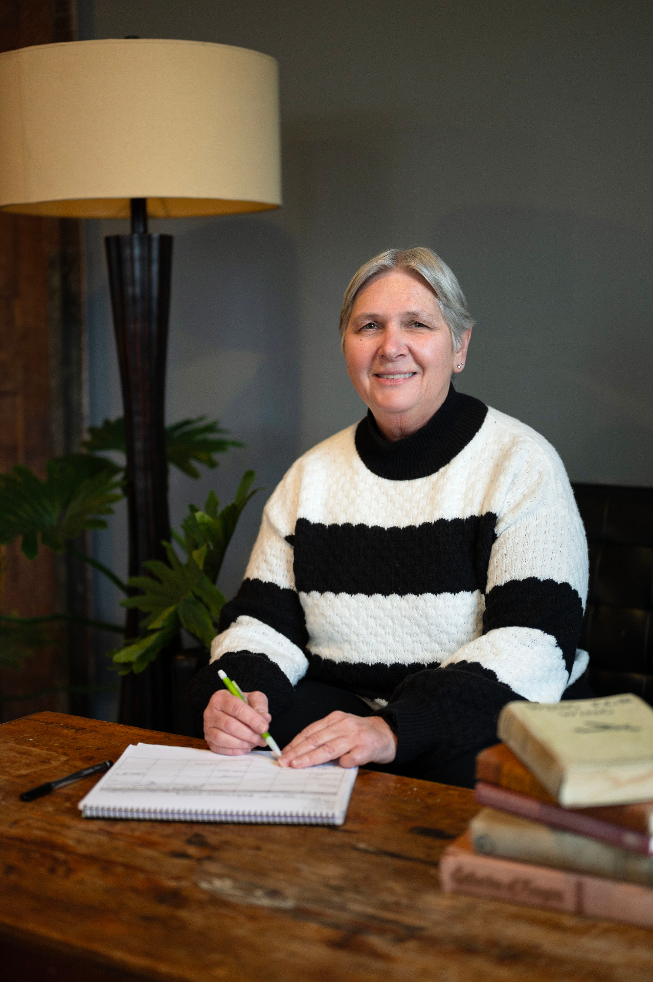 Norina Bentzel writing at a table